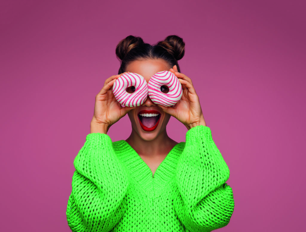 Beautiful woman holding donuts